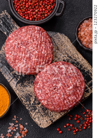 Fresh raw ground beef burger patty with salt and spices Fresh raw ground beef burger patty with salt and spices 123270922