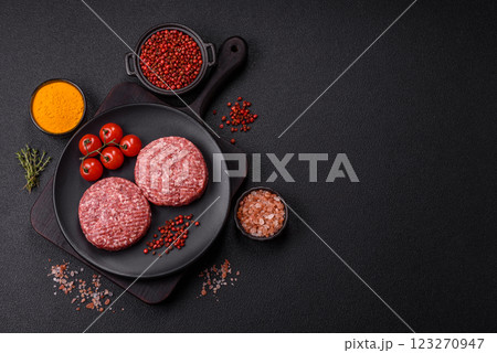 Fresh raw ground beef burger patty with salt and spices Fresh raw ground beef burger patty with salt and spices 123270947