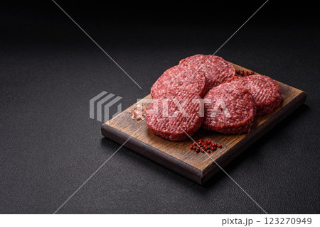 Fresh raw ground beef burger patty with salt and spices Fresh raw ground beef burger patty with salt and spices 123270949