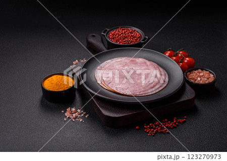 Smoked ham with salt, spices and herbs cut into round slices Smoked ham with salt, spices and herbs cut into round slices 123270973