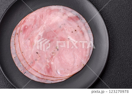 Smoked ham with salt, spices and herbs cut into round slices 123270978