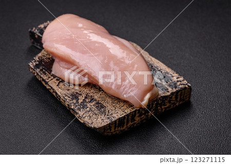 Pieces of raw chicken or turkey fillet with salt, spices and herbs Pieces of raw chicken or turkey fillet with salt, spices and herbs 123271115