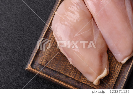Pieces of raw chicken or turkey fillet with salt, spices and herbs 123271125