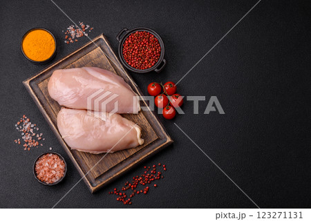 Pieces of raw chicken or turkey fillet with salt, spices and herbs Pieces of raw chicken or turkey fillet with salt, spices and herbs 123271131