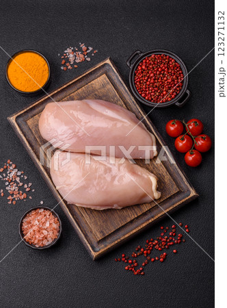 Pieces of raw chicken or turkey fillet with salt, spices and herbs Pieces of raw chicken or turkey fillet with salt, spices and herbs 123271132