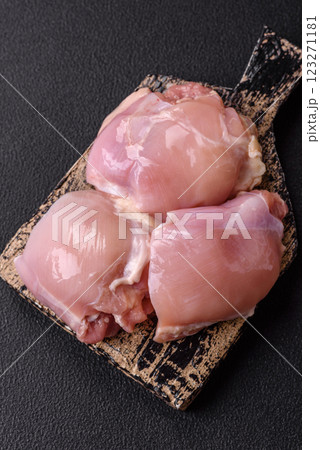 Fresh raw chicken thigh fillets with salt, spices and herbs 123271181
