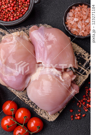 Fresh raw chicken thigh fillets with salt, spices and herbs 123271184