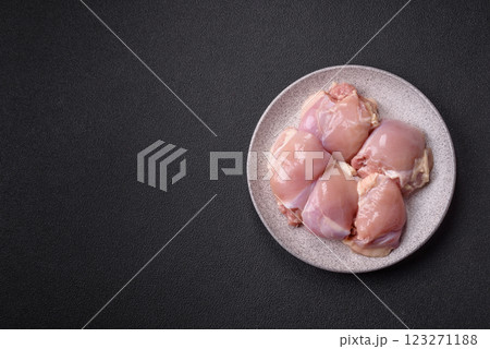 Fresh raw chicken thigh fillets with salt, spices and herbs 123271188