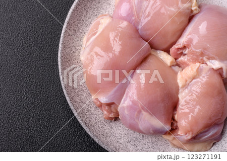 Fresh raw chicken thigh fillets with salt, spices and herbs 123271191