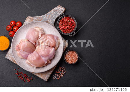 Fresh raw chicken thigh fillets with salt, spices and herbs Fresh raw chicken thigh fillets with salt, spices and herbs 123271196