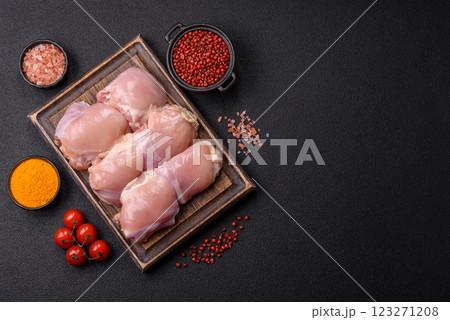 Fresh raw chicken thigh fillets with salt, spices and herbs 123271208