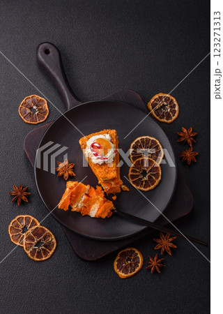 Piece of sweet layer cake with pumpkin or citrus flavor with cream 123271313