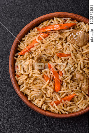 Delicious fresh pilaf with rice, carrots, meat, onions, spices and berries 123271685