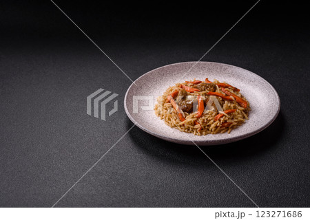 Delicious fresh pilaf with rice, carrots, meat, onions, spices and berries 123271686
