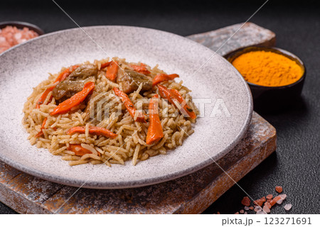 Delicious fresh pilaf with rice, carrots, meat, onions, spices and berries Delicious fresh pilaf with rice, carrots, meat, onions, spices and berries 123271691