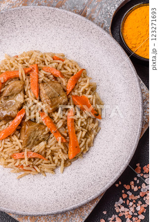 Delicious fresh pilaf with rice, carrots, meat, onions, spices and berries 123271693