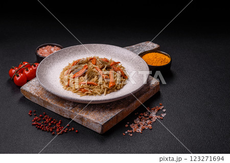 Delicious fresh pilaf with rice, carrots, meat, onions, spices and berries Delicious fresh pilaf with rice, carrots, meat, onions, spices and berries 123271694