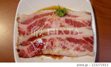 Slice of fresh beef or pork meat present in a white plate for grill, barbeque, and hot pot. Japanese Wagyu Yakiniku beef slice. 123271913
