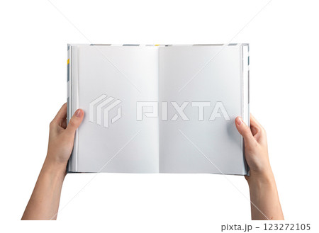 A person holding an open, blank book or journal with both hands, showcasing clean, white pages. 123272105