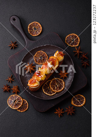 Delicious sweet eclair with chocolate filling, covered with cream 123272237