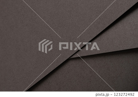 Dark espresso brown paper background with a smooth matte texture and subtle geometric lines. Rich 123272492