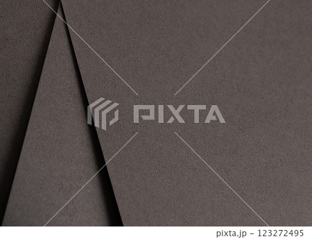 Dark espresso brown paper background with a smooth matte texture and subtle geometric lines. Rich 123272495