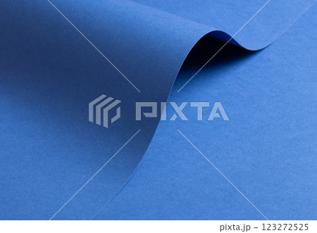 Deep sapphire blue paper background with a smooth texture and overlapping curved folds. Vibrant 123272525