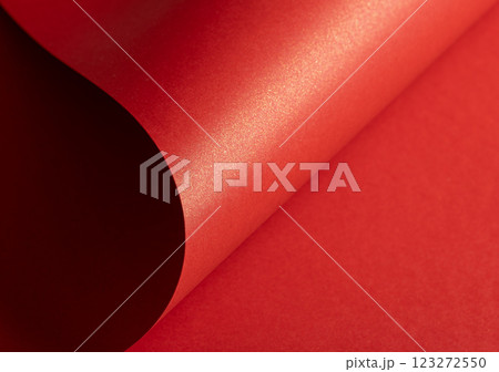 Fiery crimson paper background with a pearlescent, glossy texture and shimmering waves. Rich scarlet Fiery crimson paper background with a pearlescent, glossy texture and shimmering waves. Rich scarlet 123272550