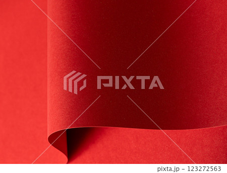 Fiery crimson paper background with a velvety smooth texture and wavy edges. Rich ruby and carmine 123272563
