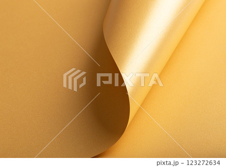Pearlescent yellow paper background with a smooth, glossy texture and shimmering edges. Soft pastel 123272634