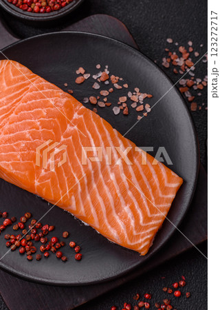 Fresh raw salmon steak with spices and herbs Fresh raw salmon steak with spices and herbs 123272717