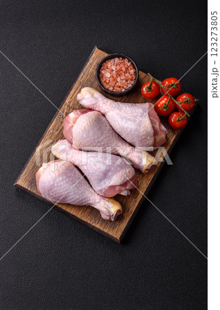 Raw chicken or turkey legs with salt, spices and herbs 123273805
