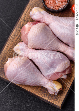 Raw chicken or turkey legs with salt, spices and herbs Raw chicken or turkey legs with salt, spices and herbs 123273808