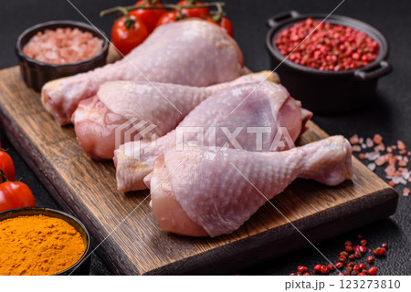 Raw chicken or turkey legs with salt, spices and herbs Raw chicken or turkey legs with salt, spices and herbs 123273810