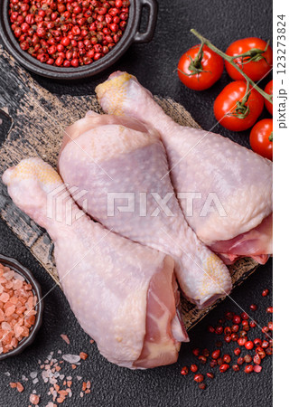 Raw chicken or turkey legs with salt, spices and herbs Raw chicken or turkey legs with salt, spices and herbs 123273824