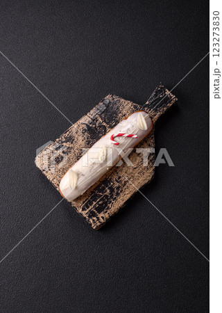 Sweet eclair with chocolate filling covered with white glaze Sweet eclair with chocolate filling covered with white glaze 123273830