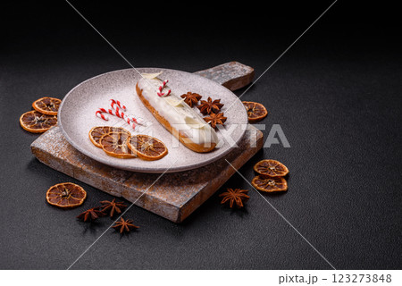 Sweet eclair with chocolate filling covered with white glaze 123273848