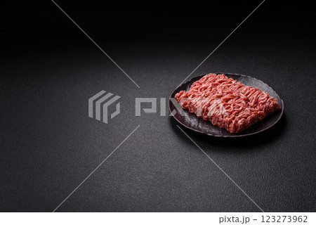 Fresh raw ground minced beef with salt and spices 123273962