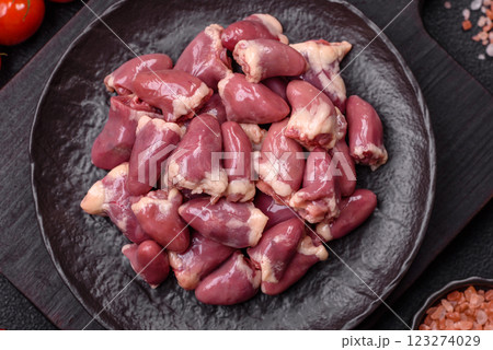 Raw chicken hearts with salt, spices and herbs 123274029