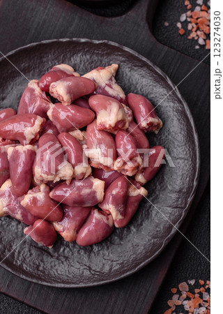 Raw chicken hearts with salt, spices and herbs 123274030