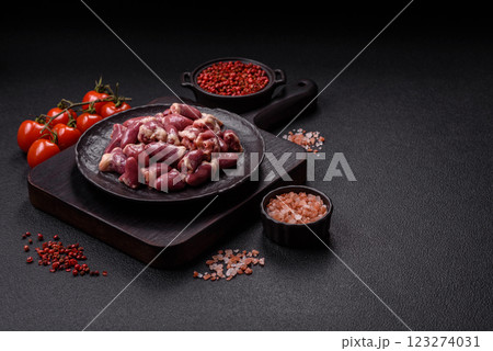 Raw chicken hearts with salt, spices and herbs Raw chicken hearts with salt, spices and herbs 123274031