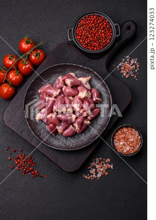 Raw chicken hearts with salt, spices and herbs Raw chicken hearts with salt, spices and herbs 123274033