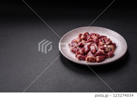 Raw chicken hearts with salt, spices and herbs Raw chicken hearts with salt, spices and herbs 123274034