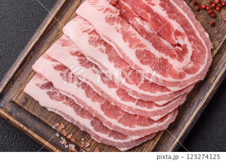 Fresh raw bacon sliced with spices and herbs Fresh raw bacon sliced with spices and herbs 123274125