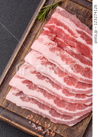 Fresh raw bacon sliced with spices and herbs Fresh raw bacon sliced with spices and herbs 123274126