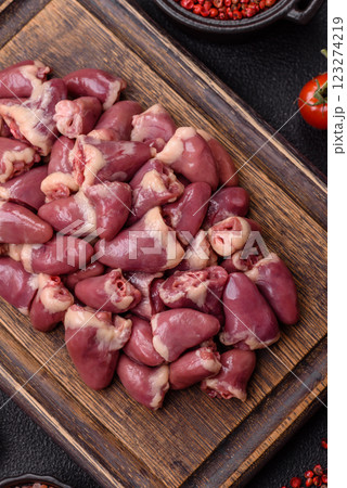 Raw chicken hearts with salt, spices and herbs 123274219
