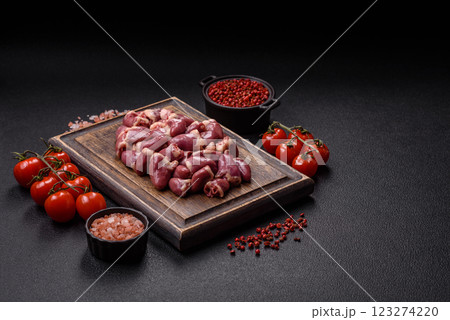 Raw chicken hearts with salt, spices and herbs Raw chicken hearts with salt, spices and herbs 123274220