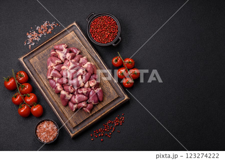 Raw chicken hearts with salt, spices and herbs 123274222
