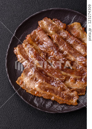 Crispy fried pork bacon sliced with salt, spices and herbs 123274309