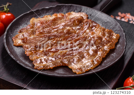 Crispy fried pork bacon sliced with salt, spices and herbs 123274310